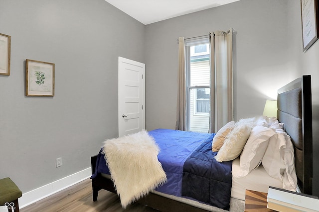 bedroom with hardwood / wood-style flooring