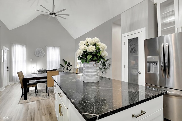 kitchen featuring light hardwood / wood-style flooring, white cabinetry, high vaulted ceiling, and stainless steel fridge with ice dispenser