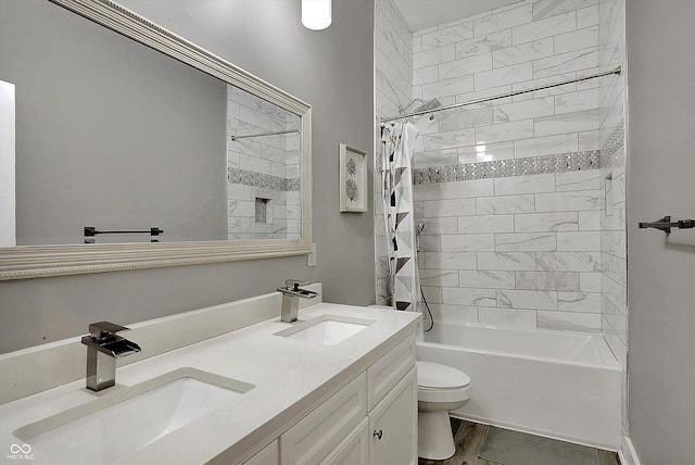 full bathroom with vanity, toilet, and tiled shower / bath