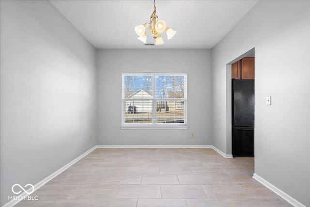 unfurnished dining area with a chandelier