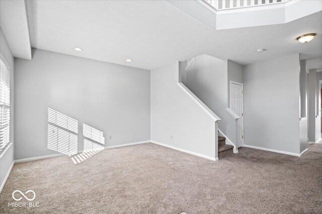 unfurnished living room featuring carpet