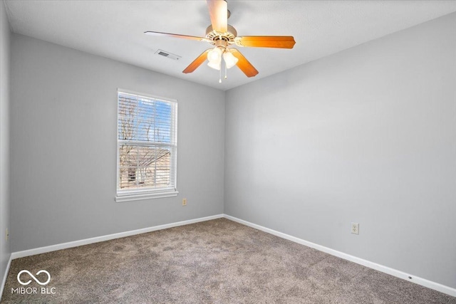 empty room featuring carpet floors and ceiling fan