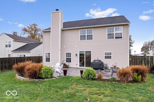 back of house featuring a yard and a patio