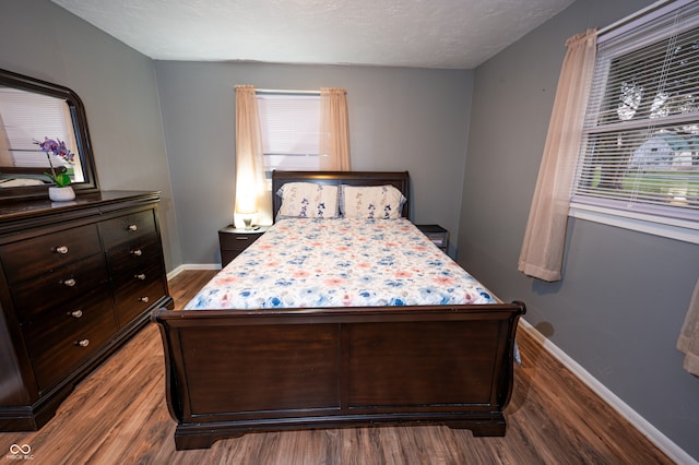 bedroom featuring hardwood / wood-style floors and a textured ceiling