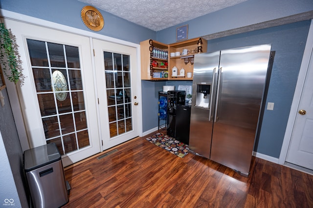 kitchen with french doors, a textured ceiling, stainless steel fridge, and dark hardwood / wood-style floors