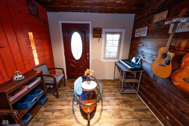 entrance foyer featuring hardwood / wood-style floors and wood walls