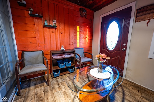 entrance foyer with wood walls, hardwood / wood-style flooring, and wood ceiling