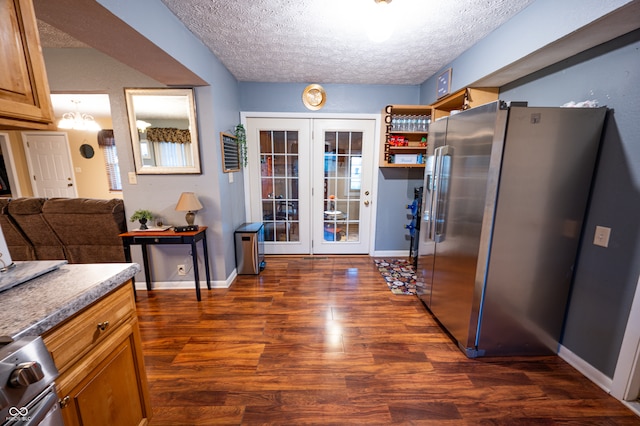 kitchen featuring a textured ceiling, stainless steel refrigerator, dark hardwood / wood-style floors, and french doors