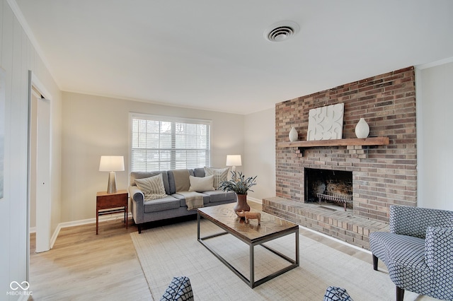 4902 N Capitol Ave, Indianapolis, IN 46208 - living room featuring light wood-style floors, a fireplace, ornamental molding, and baseboards