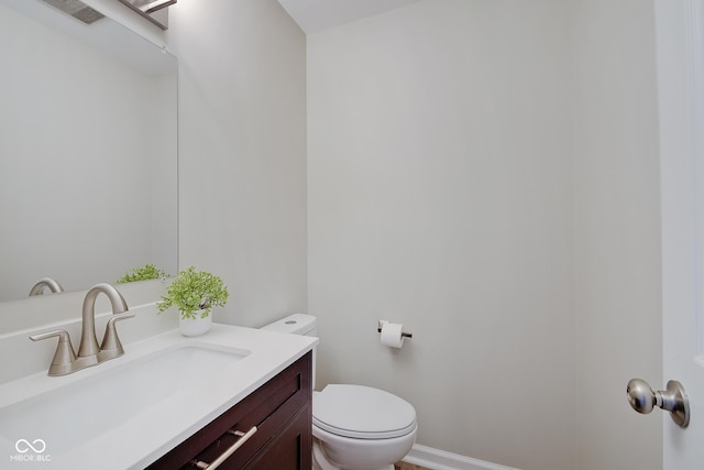 4902 N Capitol Ave, Indianapolis, IN 46208 - half bathroom with vanity, toilet, and baseboards