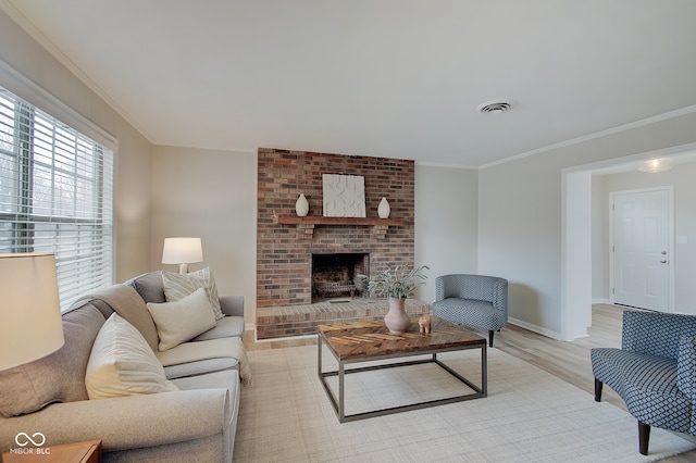 living room featuring a brick fireplace, light hardwood / wood-style floors, and ornamental molding