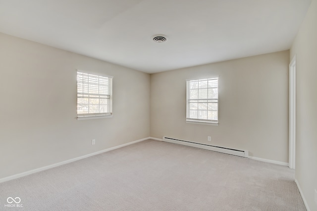 carpeted empty room featuring a baseboard radiator