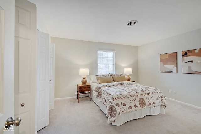 bedroom with baseboard heating and light colored carpet