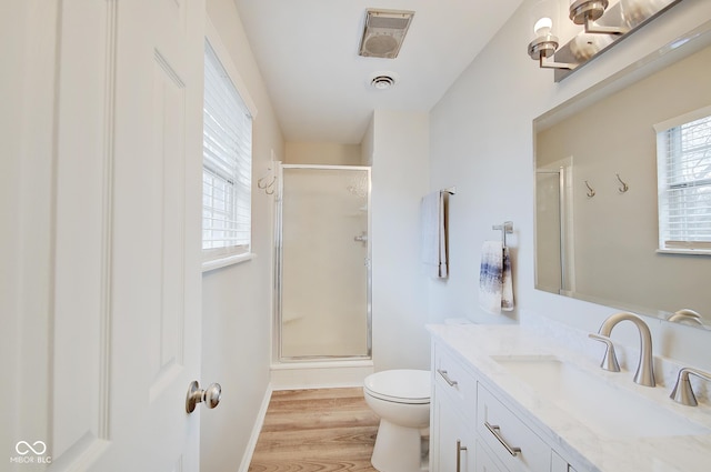 4902 N Capitol Ave, Indianapolis, IN 46208 - bathroom with toilet, vanity, a stall shower, wood finished floors, and baseboards