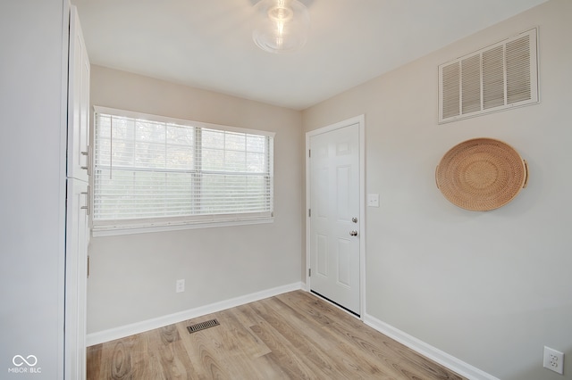 spare room with light hardwood / wood-style flooring