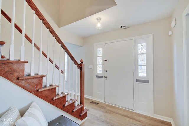 4902 N Capitol Ave, Indianapolis, IN 46208 - foyer entrance featuring wood finished floors, stairs, and baseboards