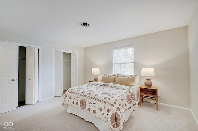 4902 N Capitol Ave, Indianapolis, IN 46208 - bedroom with two closets, light colored carpet, and baseboards
