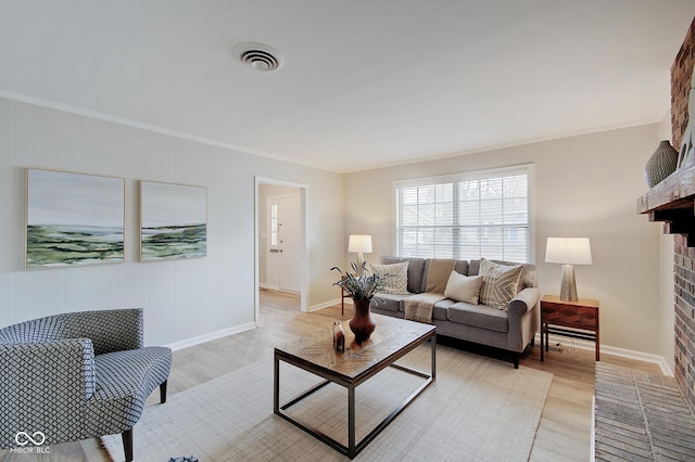 4902 N Capitol Ave, Indianapolis, IN 46208 - living room featuring light wood-style flooring, crown molding, baseboards, and a fireplace