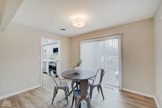 dining area with light hardwood / wood-style floors