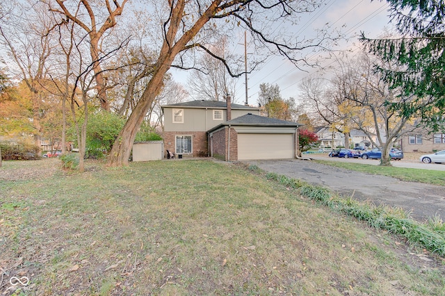 view of front of property featuring a garage and a front lawn