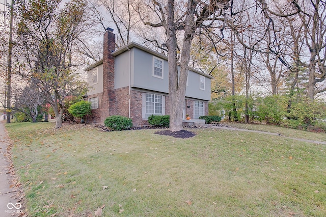 4902 N Capitol Ave, Indianapolis, IN 46208 - view of front facade featuring a chimney, brick siding, a front lawn, and stucco siding