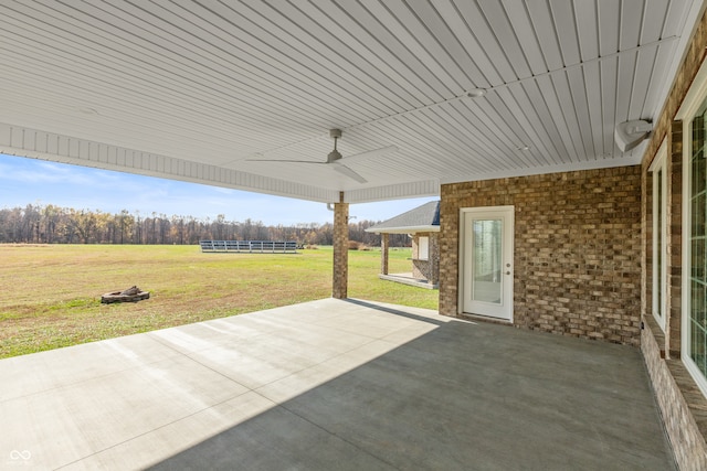 view of patio / terrace featuring ceiling fan and a rural view