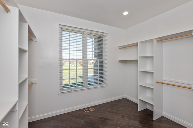 walk in closet with dark hardwood / wood-style flooring