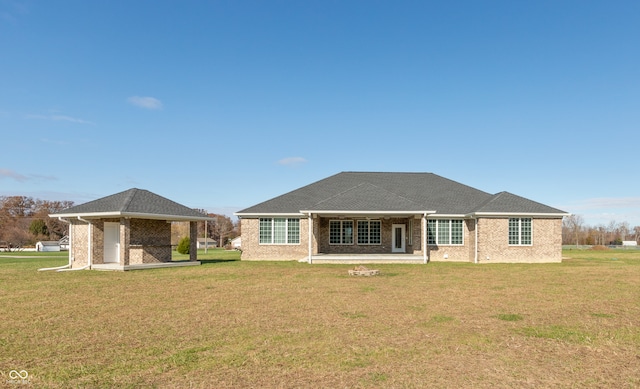 back of house with a lawn