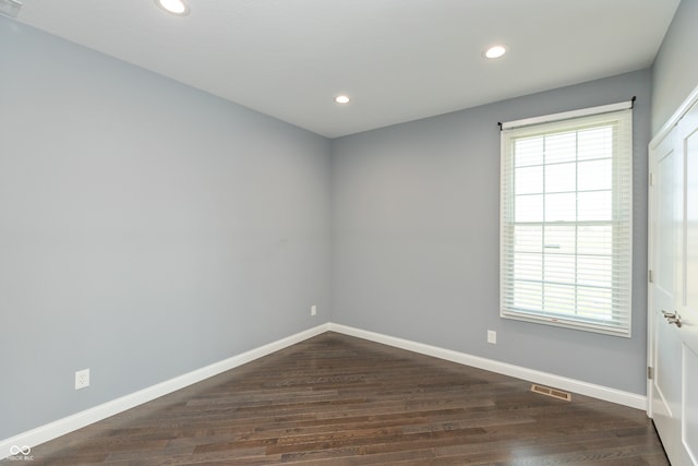 unfurnished room featuring dark wood-type flooring