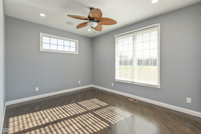 spare room with dark hardwood / wood-style floors and ceiling fan