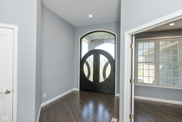 foyer entrance featuring french doors and dark hardwood / wood-style floors