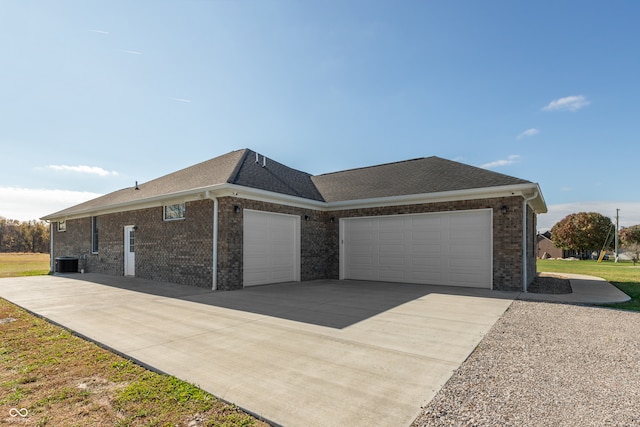 exterior space featuring central AC unit and a garage