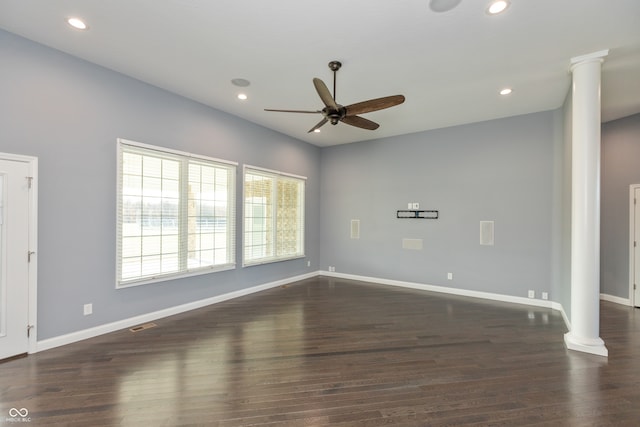 unfurnished room featuring dark hardwood / wood-style flooring, decorative columns, and ceiling fan