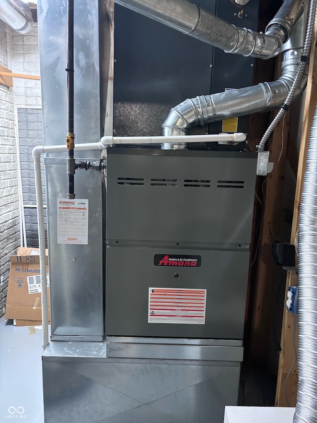 utility room featuring heating unit