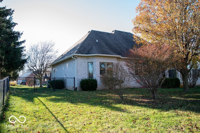 view of side of property with a yard