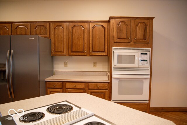 kitchen with wood-type flooring and white appliances