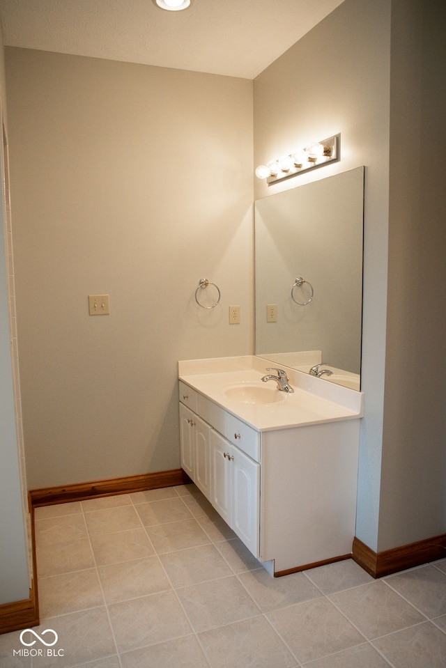 bathroom with tile patterned flooring and vanity