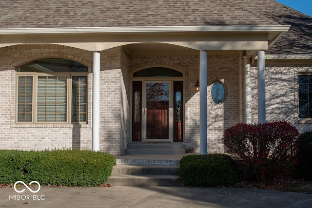 view of exterior entry featuring covered porch