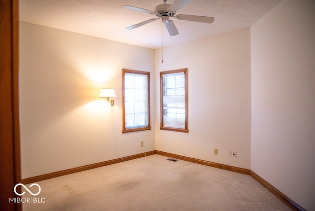 unfurnished room featuring ceiling fan and light colored carpet