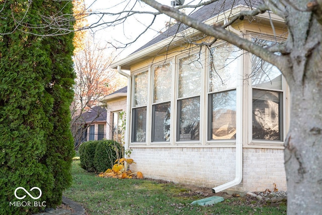 view of property exterior featuring a sunroom