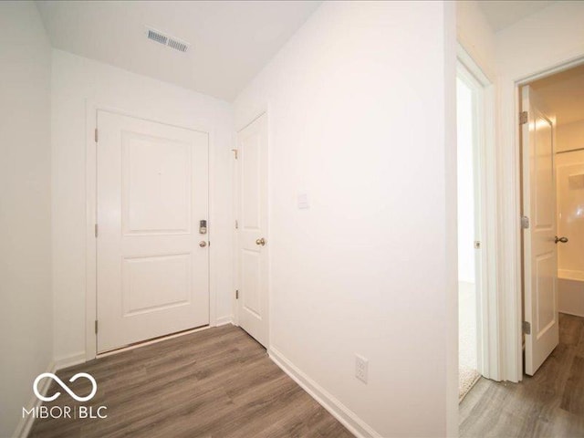 corridor featuring dark hardwood / wood-style floors