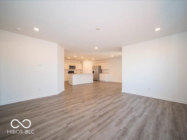 unfurnished living room with light hardwood / wood-style floors