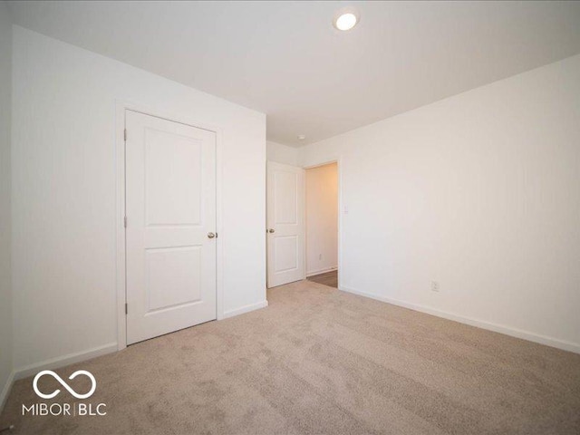 unfurnished bedroom with light carpet