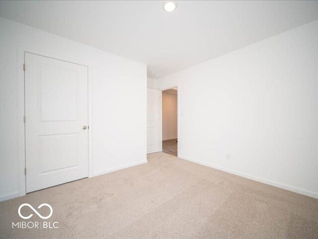 unfurnished bedroom with light colored carpet