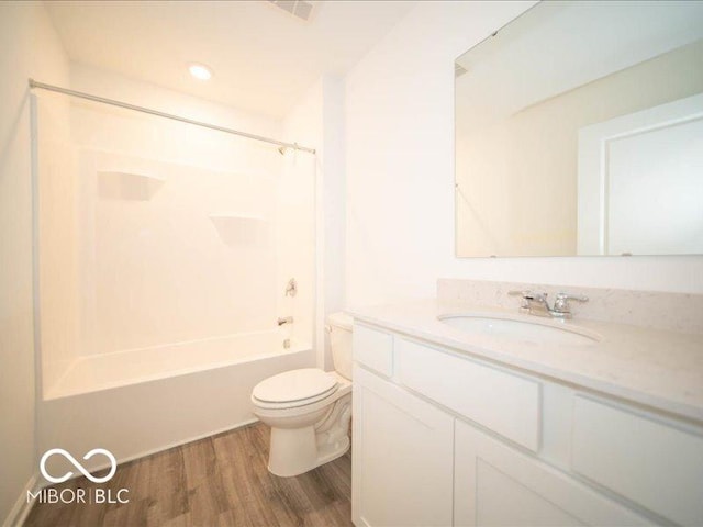 full bathroom featuring vanity, toilet, wood-type flooring, and bathtub / shower combination