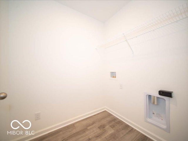 laundry area with hardwood / wood-style floors and washer hookup