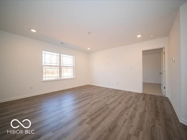 empty room featuring dark hardwood / wood-style flooring