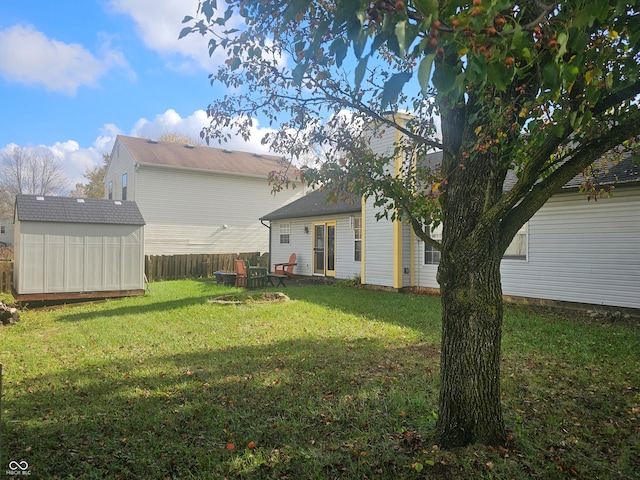 back of property with a storage unit, a yard, and a patio