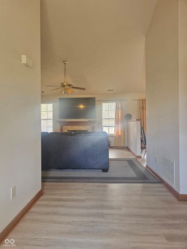 unfurnished living room with light hardwood / wood-style floors and ceiling fan