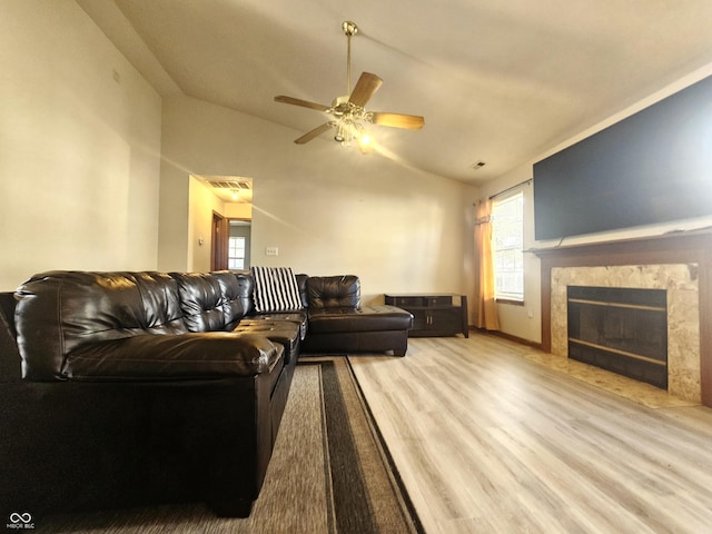 living room with light wood-type flooring, ceiling fan, and vaulted ceiling